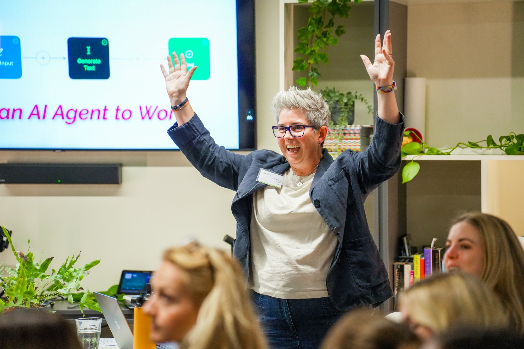 Caron Saul speaking on AI agents at a business event